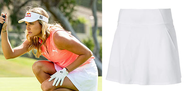 Lexi Thompson Squatting to line up a golf shot in orange top and white skirt